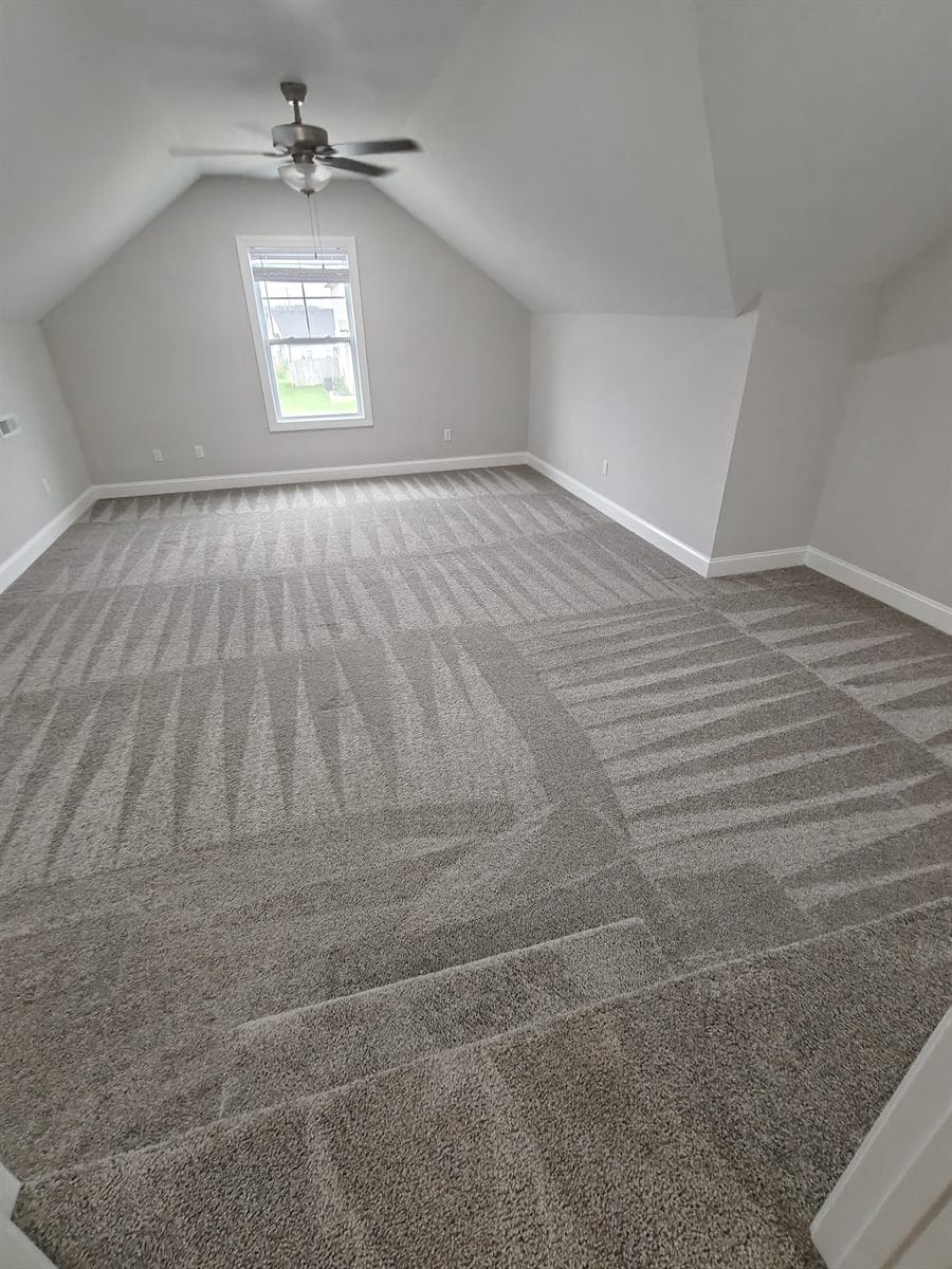 Freshly vacuumed carpet in a bonus room, showing clean sweep lines